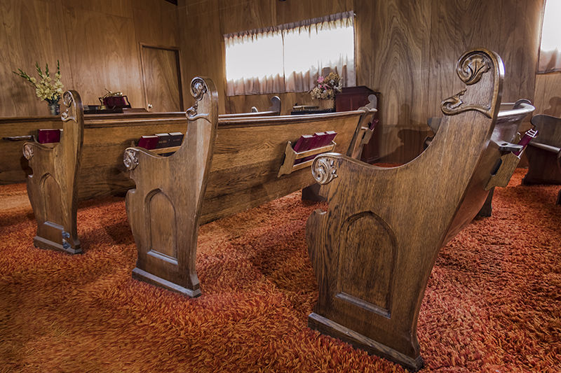 Detail of end design of antique oak pews