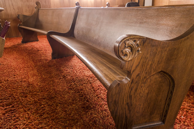Detail showing curve of pews and contoured seat bench